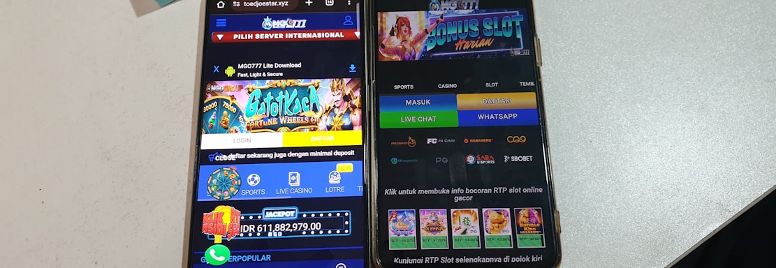 Two smartphones are displayed on a white surface, both showing gambling websites with colorful graphics, text, and various options for logging in and accessing games. The screens are bright and filled with promotional content related to casino and slot games.
